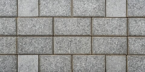 Fototapeta premium A Seamless Pattern of Gray Rectangular Stone Blocks Creates a Textured Wall