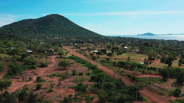 Aerial view of African villages with huts among trees near Lake Victoria, Africa's largest and the world's second-largest freshwater lake, known locally as Nam Lolwe, Nalubaale, or Nyanza.