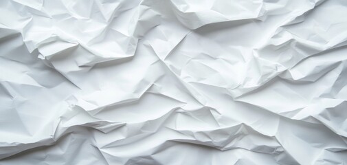 Obraz premium A close-up view of crumpled white paper, showcasing texture and depth for use in design or artistic projects.