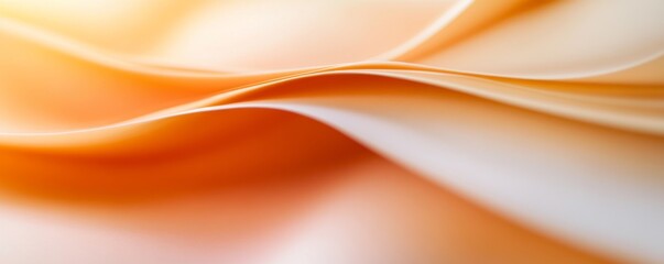 Obraz premium Soft, flowing fabric in warm shades of orange and cream, evoking a sense of comfort and elegance, perfect for backgrounds and textures.