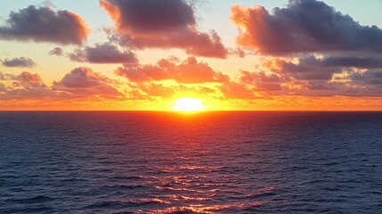 Fototapeta premium Serene sunrise over the ocean with vibrant colors reflecting on calm waters and clouds enhancing the tranquil morning atmosphere