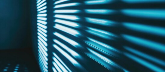 Blue window blinds casting abstract shadows with sunlight creating a striking background for modern designs or wallpapers.