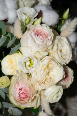 Close-up of a bouquet of peony roses on a dark background. A perfect representation of beauty, romance, and floral elegance.