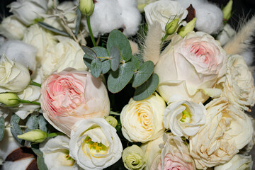 Close-up of blooming roses in a soft pastel bouquet. A beautiful floral arrangement perfect for celebrations or greeting cards.