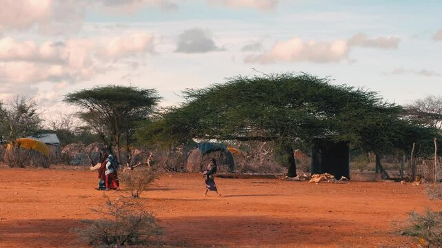 
 Portrait of people in an African village.  Of huts among trees. Everyday life on the streets, green forests, and vegetation. African village life.