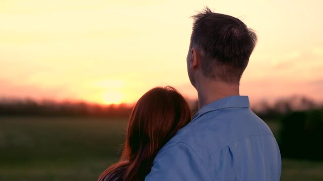 man woman happy family man embracing his beloved sunset, man woman happy family couple tender hug dusk, sunset embrace, man woman happy family loving moment twilight, sunset cuddle lovers, intimate