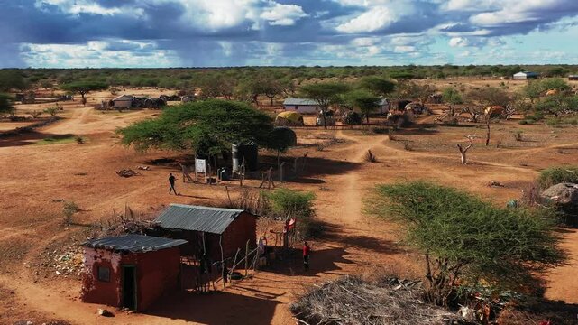  African village. Aerial view of an African village with small huts among the trees. People on the streets of Africa, everyday life. African village life. African Forests Green Vegetation View.