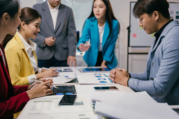 Fototapeta premium Business team discussing and analyzing charts and reports during a productive meeting, fostering collaboration and strategic decision-making