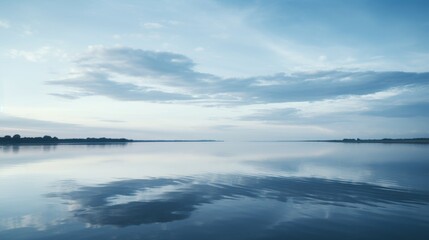 Tranquil lake reflections  a minimalist scene of blue sky, white clouds, and green surroundings
