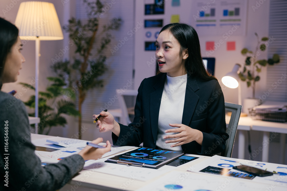 Poster two asian businesswomen are discussing company performance and analyzing financial charts and graphs