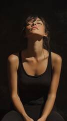 Serenity in dramatic ambient light: female figure in relaxed pose capturing tranquility and contemplation