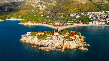 Sveti Stefan, one of Montenegro's most iconic destinations, captured from the drone, showcases its stunning beauty from above. This small islet, connected to the mainland by a narrow causeway