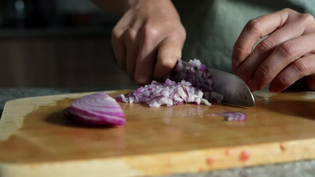 woman chopping tomato to prepare a guacamole typical of mexico 