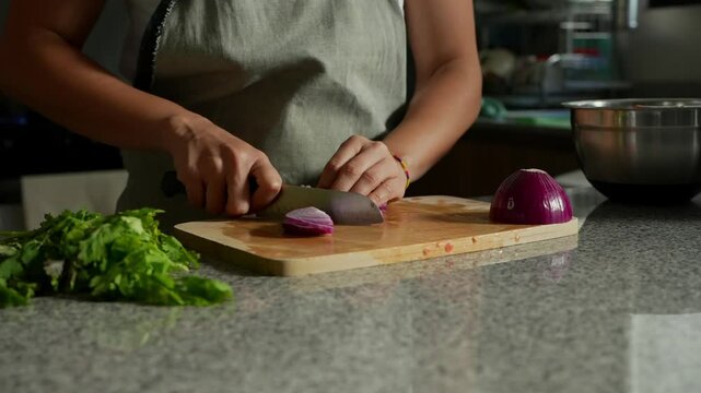 woman chopping tomato to prepare a guacamole typical of mexico 