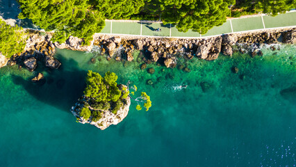 A stunning aerial view of Brela, Croatia, showcasing the iconic Kamen Brela rock formation...