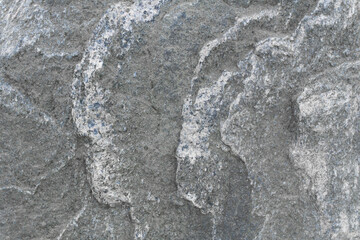 Stone texture: A smooth but slightly matte surface of a stone, with visible edges in places and a color gradient ranging from light beige to grayish brown.