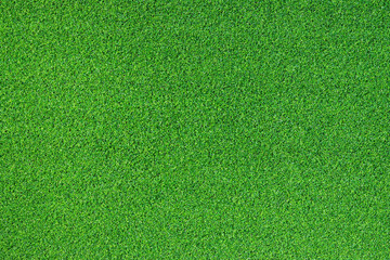 Artificial grass, covering. Artificial green grass mat, top view. Texture. Background. Artificial turf, surface made of synthetic fibers. Flat green grass texture background. Short grass