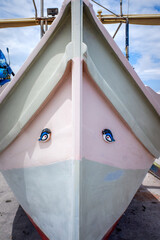 Painted eyes on the front of a colourful boat