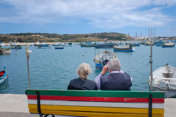 Couple sitting on a bench in the harbour