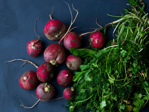 fresh radishes on a wooden table with herbs