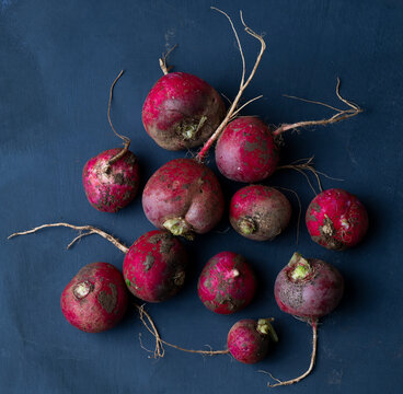 bunch of radishes on a wooden table
