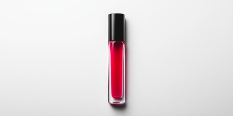 A small bottle of red lipstick is sitting on a white background
