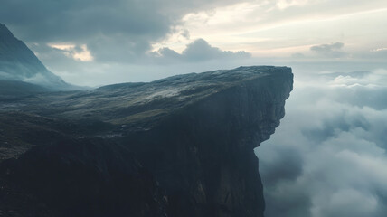 Dramatic mountain cliff with clouds and panoramic view of natural landscape during sunrise scene