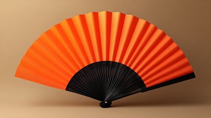 A vibrant orange hand fan with black detailing stands elegantly