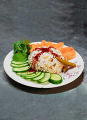 Cooked rice served with raw vegetables and spices 9:16 with salad meal name is pilav