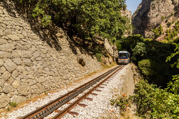 Train at narrow gauge Odontotos railway in Vouraikos Gorge on Peloponnese peninsula, Greece.