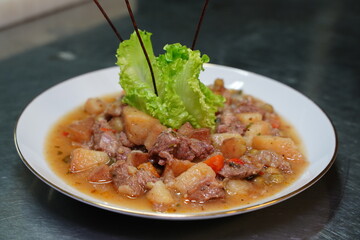 Delicious meal with potatoes and red meat close up v2