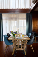 An Elegant and Modern Dining Room Featuring Charming Decor and Plenty of Natural Light