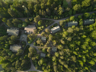 A beautiful aerial view showcases homes nestled peacefully among the lush green forest