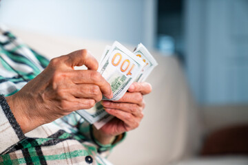 Close-up female hand counting US dollars. Financial business concept