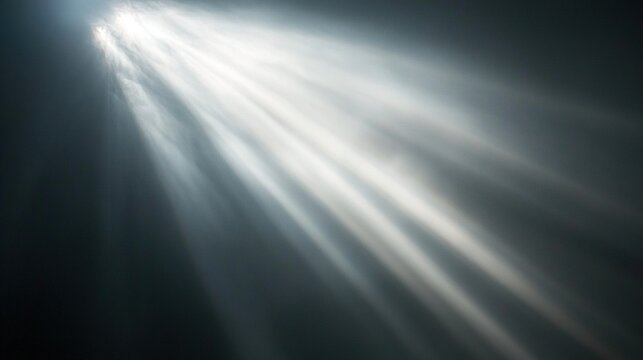 Bright light rays shining through dark smoky atmosphere.