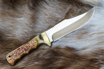 hunting knife with an antler shank stuck in the stake