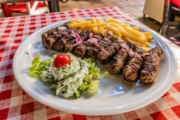 Typical dish of Serbia - cevapi grilled minced meat with french fries and salad