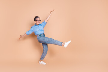 Photo portrait of gray hair retired experienced business lady wearing formalwear dancing at weekend isolated on beige color background