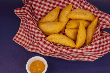 Colombian empanada with spicy sauce 