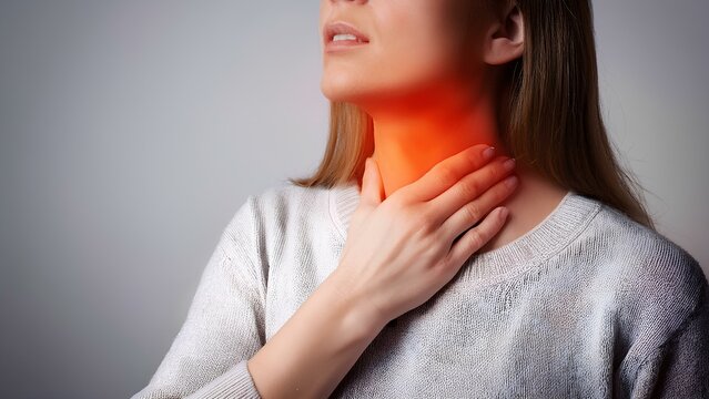 Sore throat, tonsillitis, inflammation. Woman with sore throat, inflamed tonsils from flu symptoms.