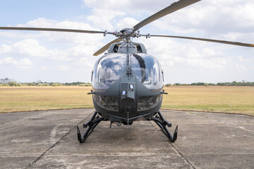 Gray painted modern H145M military transport helicopter stationary on the ground