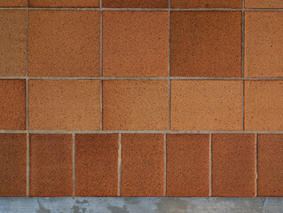 Naklejka premium Top view of reddish brown rustic natural stoneware outdoor floor. Classic rough anti-slip matte terracotta ceramic square tiles, rectangular slab border, paving, terrace, porch, patio, pool exterior.