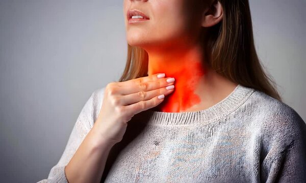 Sore throat, tonsillitis, inflammation. Woman with sore throat, inflamed tonsils from flu symptoms.