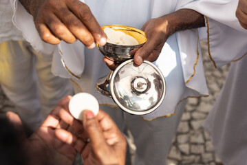 Catholics are seen receiving the host during mass on the last Friday of 2024. Bonfim Church,...