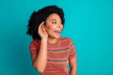 Photo of pretty young girl ear eavesdrop wear t-shirt isolated on teal color background