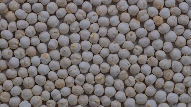 Top down view. Heap of Turkish style white roasted chickpeas in close detail. Slider shot. Food, nutrition, healthy eating, snacks, ingredient concepts. 4k