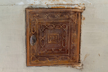 old rusty fuel door to the stove close-up