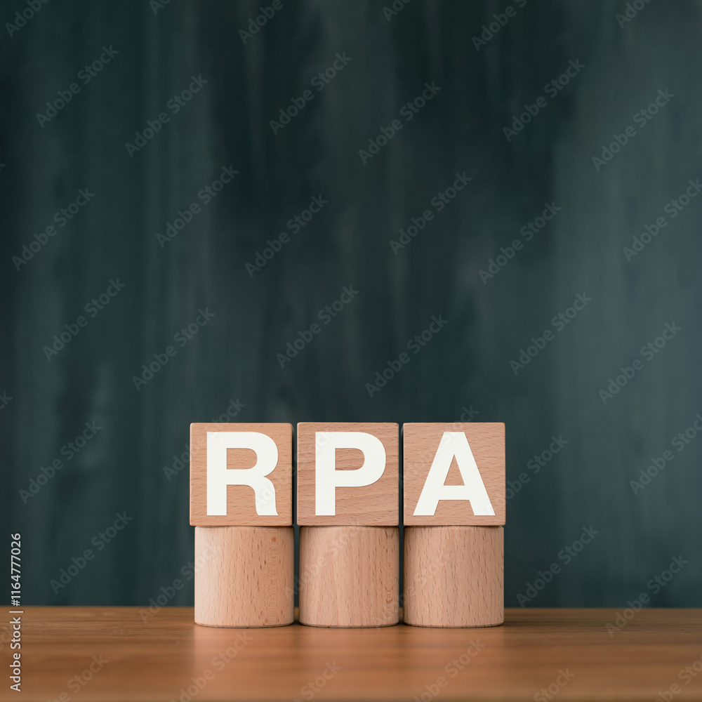 Aufkleber there is wood cube with the word rpa. it is an abbreviation for robotic process automation as eye-ca