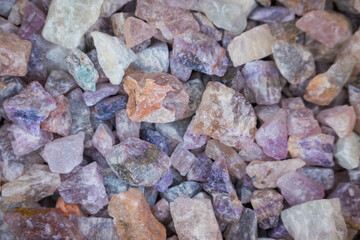 Close up view of purple mineral rocks up for sale in the market.