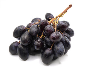 Autumn royal grapes or black seedless grapes isolated on a clean white background